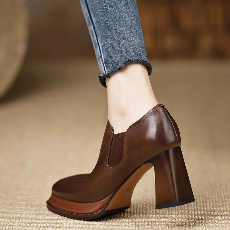 Back view of brown leather pump showing chunky block heel