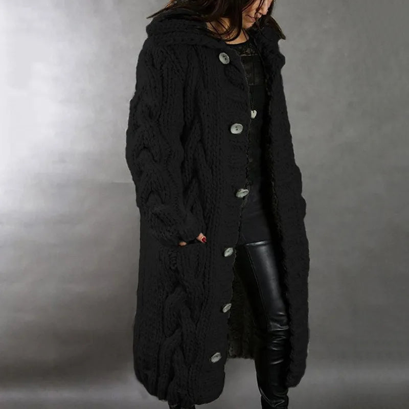 Woman wearing black hooded cable knit long cardigan, side view