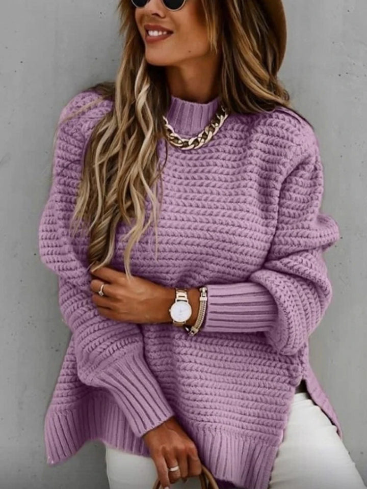 Woman wearing purple chunky knit oversized sweater with mock neck