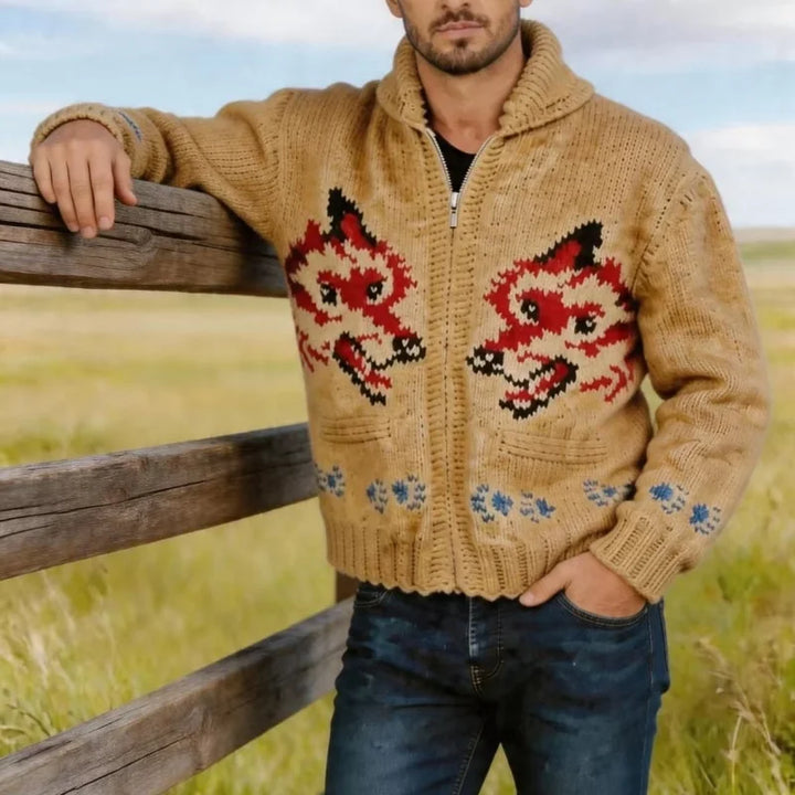 Man wearing camel fox graphic knit cardigan leaning on wood fence