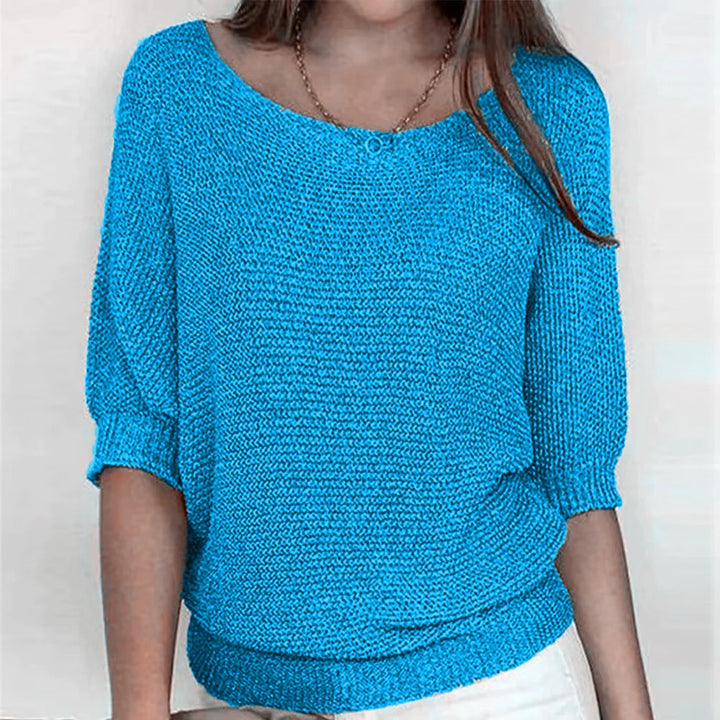 Bright blue knit top with scoop neckline and three-quarter batwing sleeves
