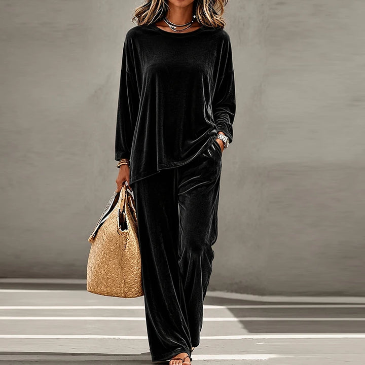 Woman wearing black velvet two piece pants set
