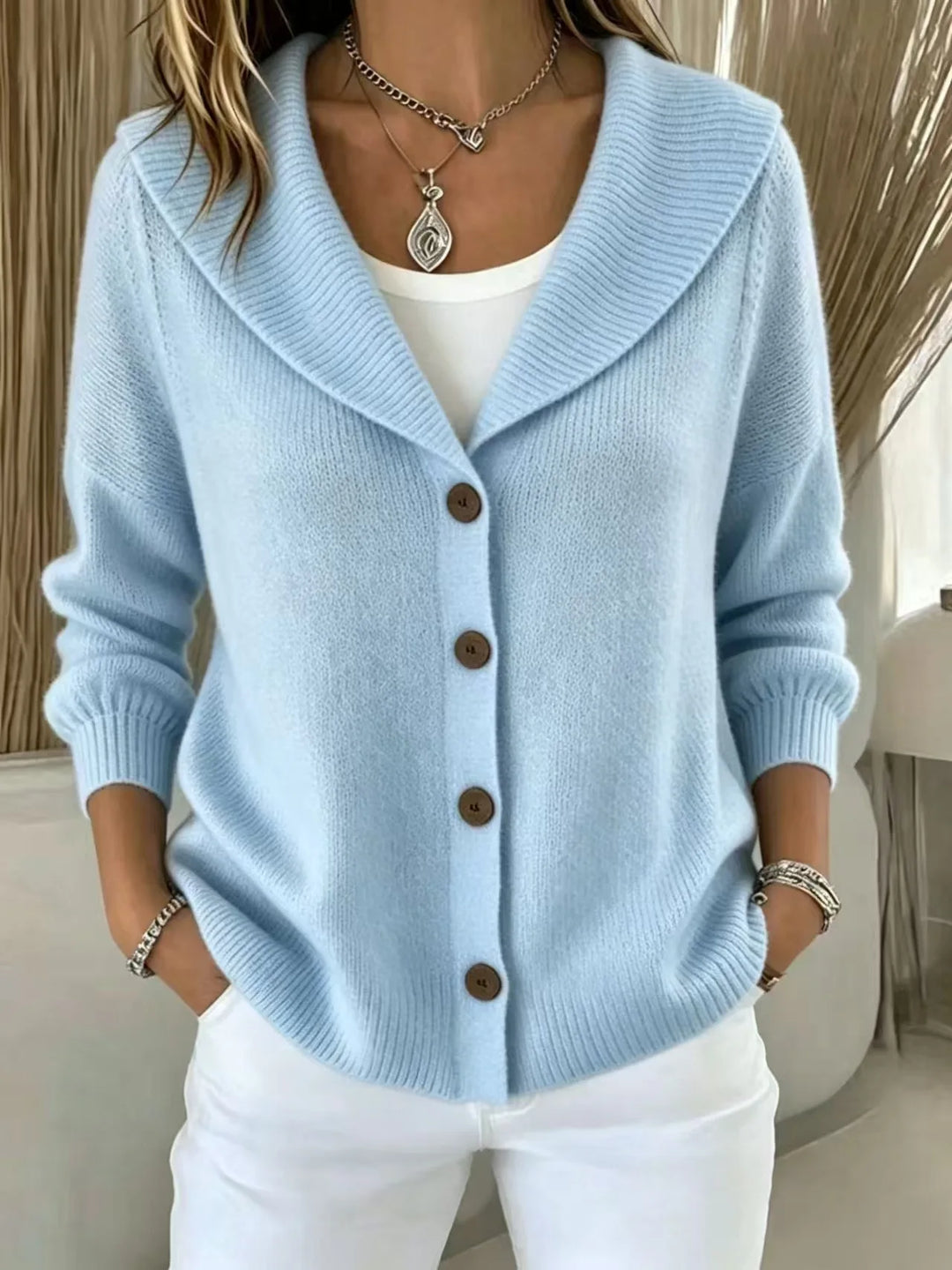 Woman wearing sky blue shawl collar button front cardigan
