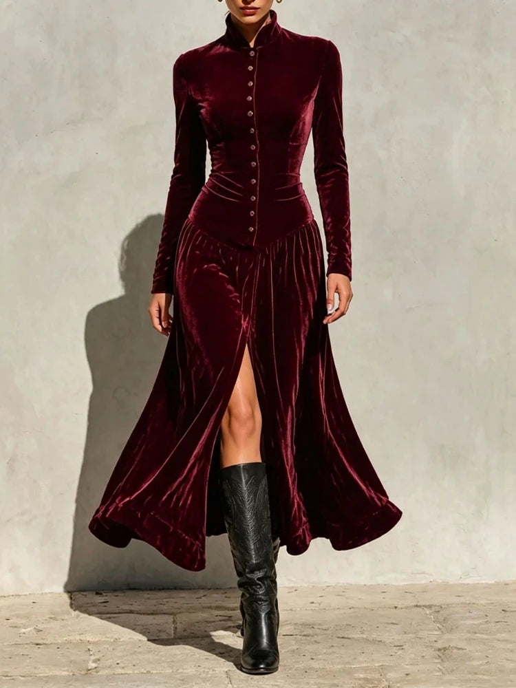 Woman wearing burgundy velvet maxi dress with stand collar and button front, front view