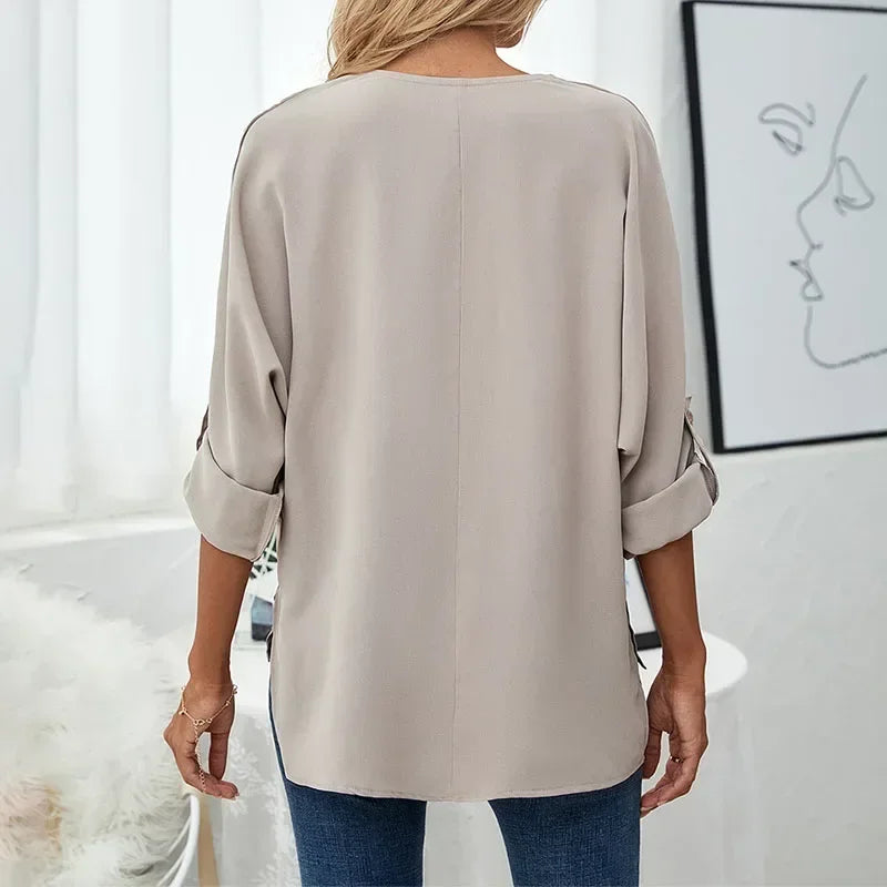 Back view of taupe oversized blouse with rolled sleeves