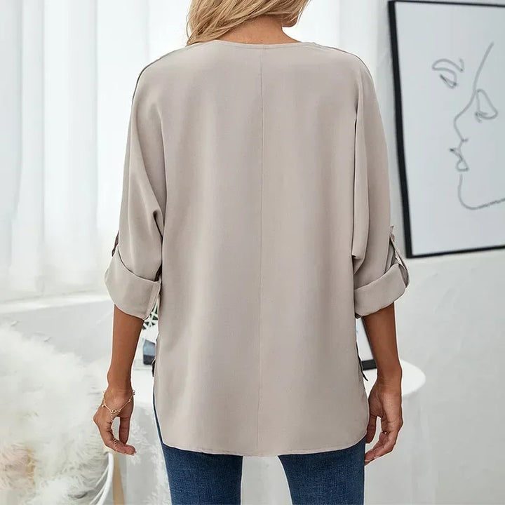 Back view of taupe oversized blouse with rolled sleeves