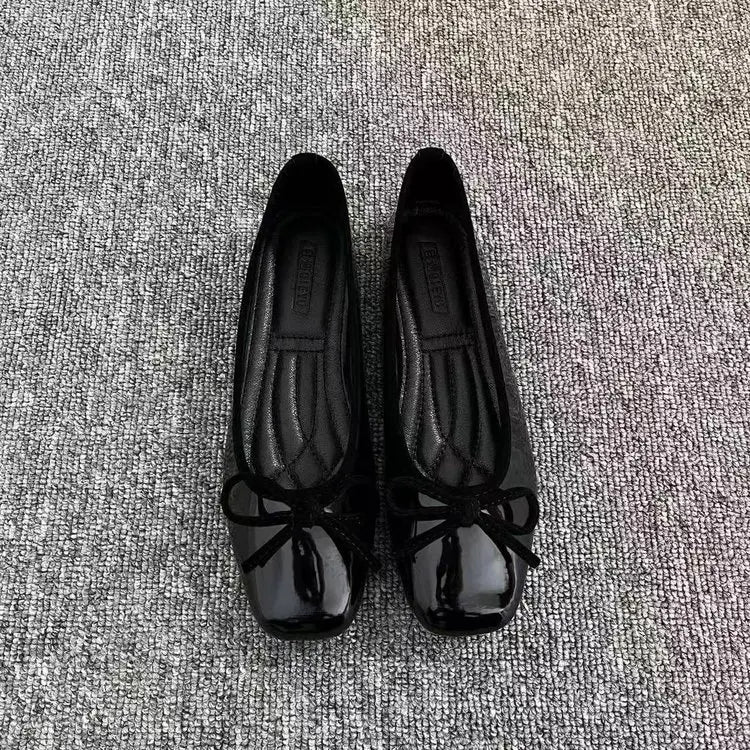Black ballet flats with bow detail, top view
