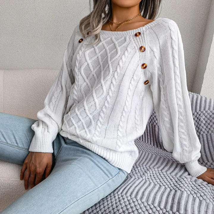 Woman wearing white cable knit sweater with square neckline buttons