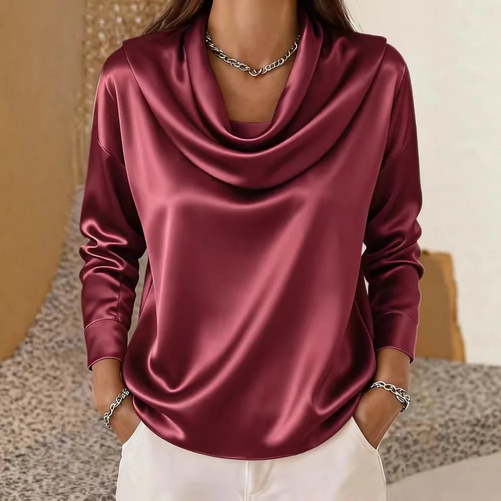 Woman wearing burgundy satin cowl neck blouse with long sleeves