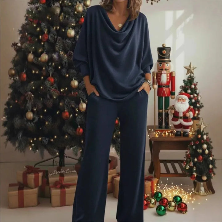 Woman wearing navy blue cowl neck knit top and wide leg pants set