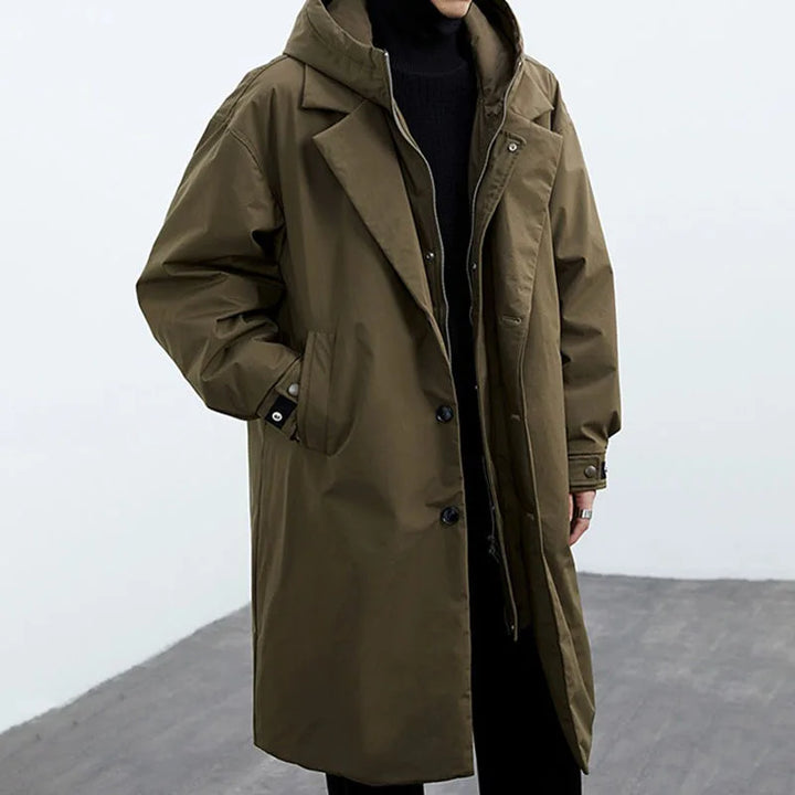 Man wearing army green hooded trench coat, front view