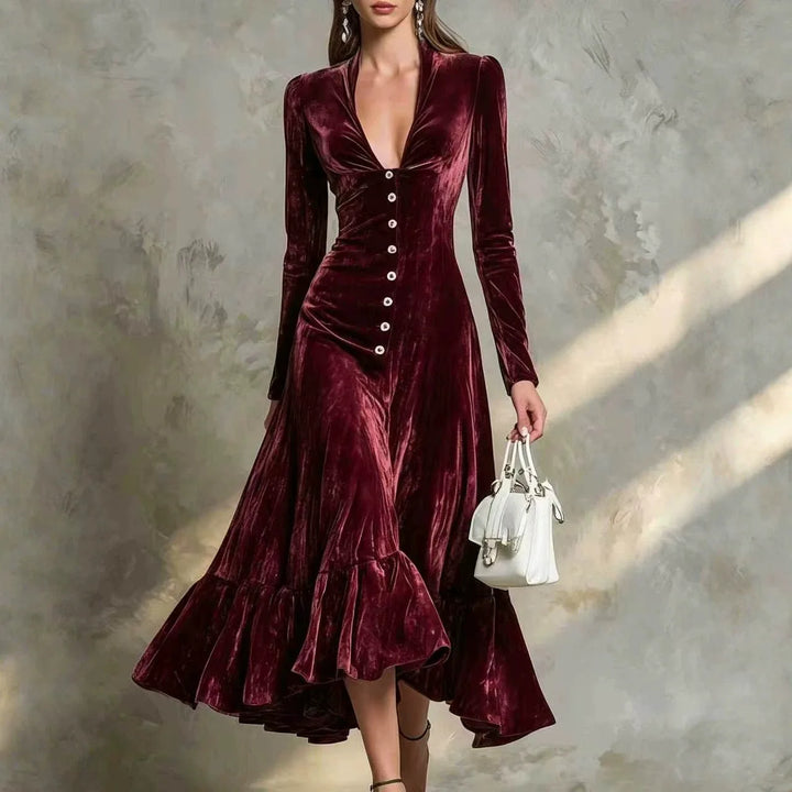 Woman in burgundy velvet midi dress with ruffled high-low hem