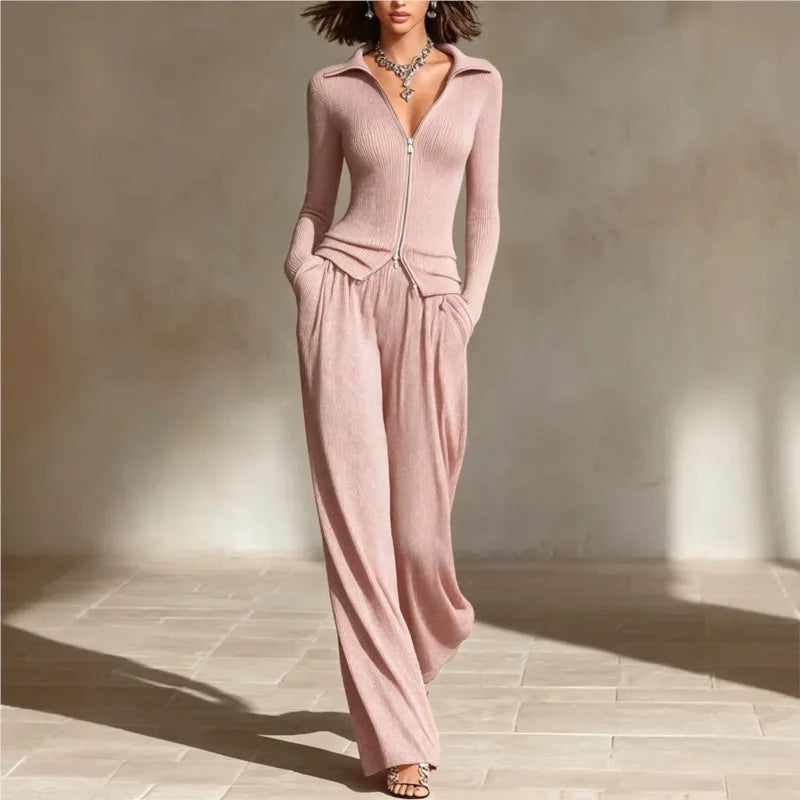 Woman wearing pink ribbed knit two piece set with zip front top and wide leg pants