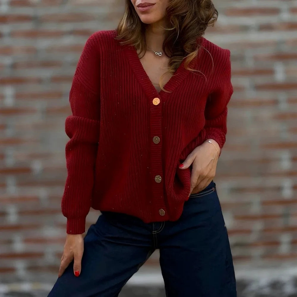 Woman wearing burgundy ribbed knit cardigan with V neckline