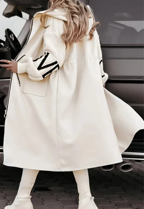 Ivory hooded long trench coat, back view showing flowing hem