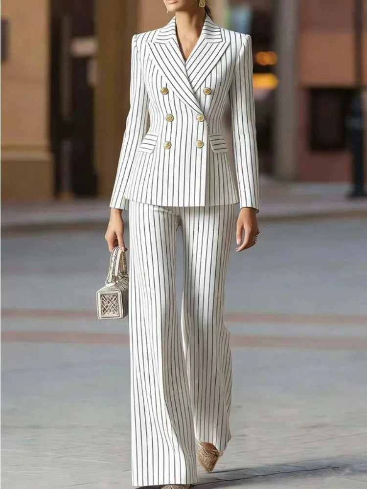 Woman wearing white pinstripe double-breasted pant suit walking outdoors