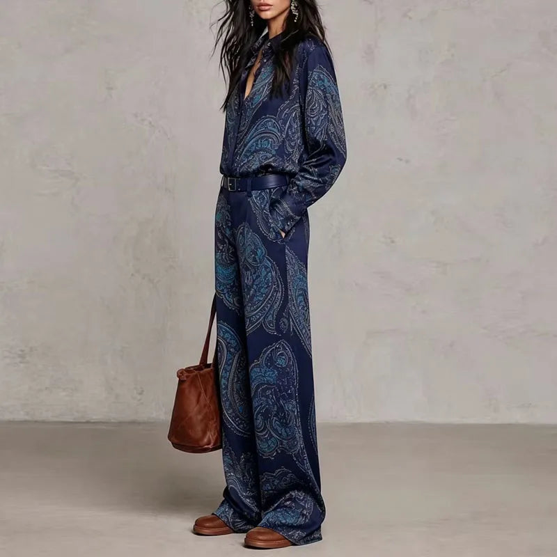 Side view of dark blue paisley print shirt and wide leg pants set