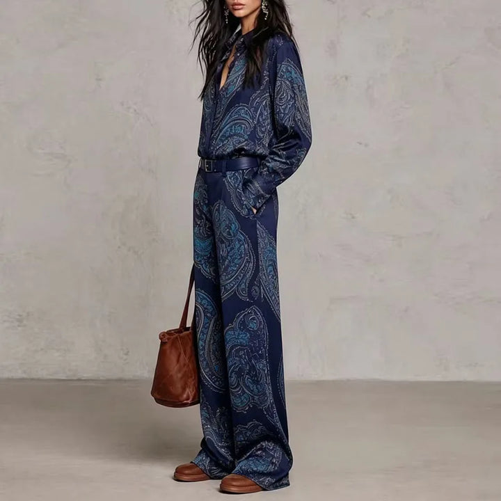 Side view of dark blue paisley print shirt and wide leg pants set