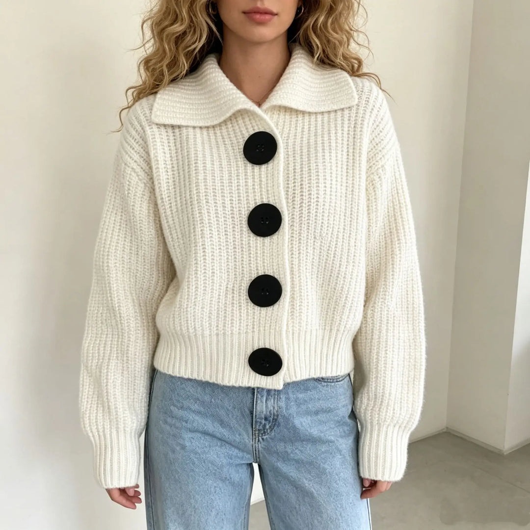 Woman wearing ivory ribbed knit cardigan with black buttons and collar