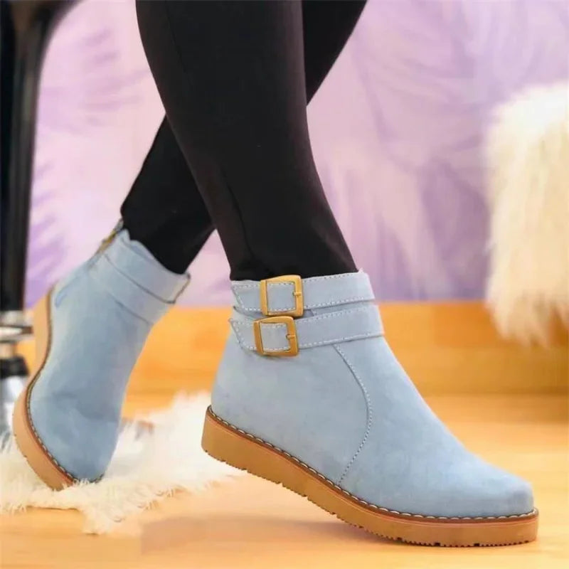 Light blue suede ankle boot with double buckle straps, side view