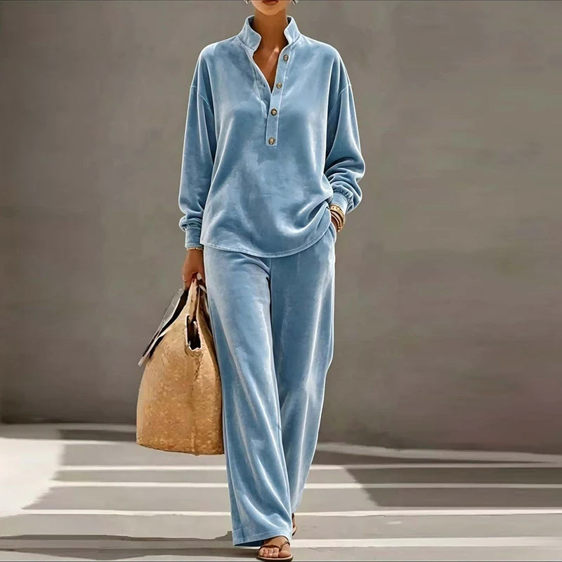 Woman wearing light blue velvet stand collar top and wide leg pants set