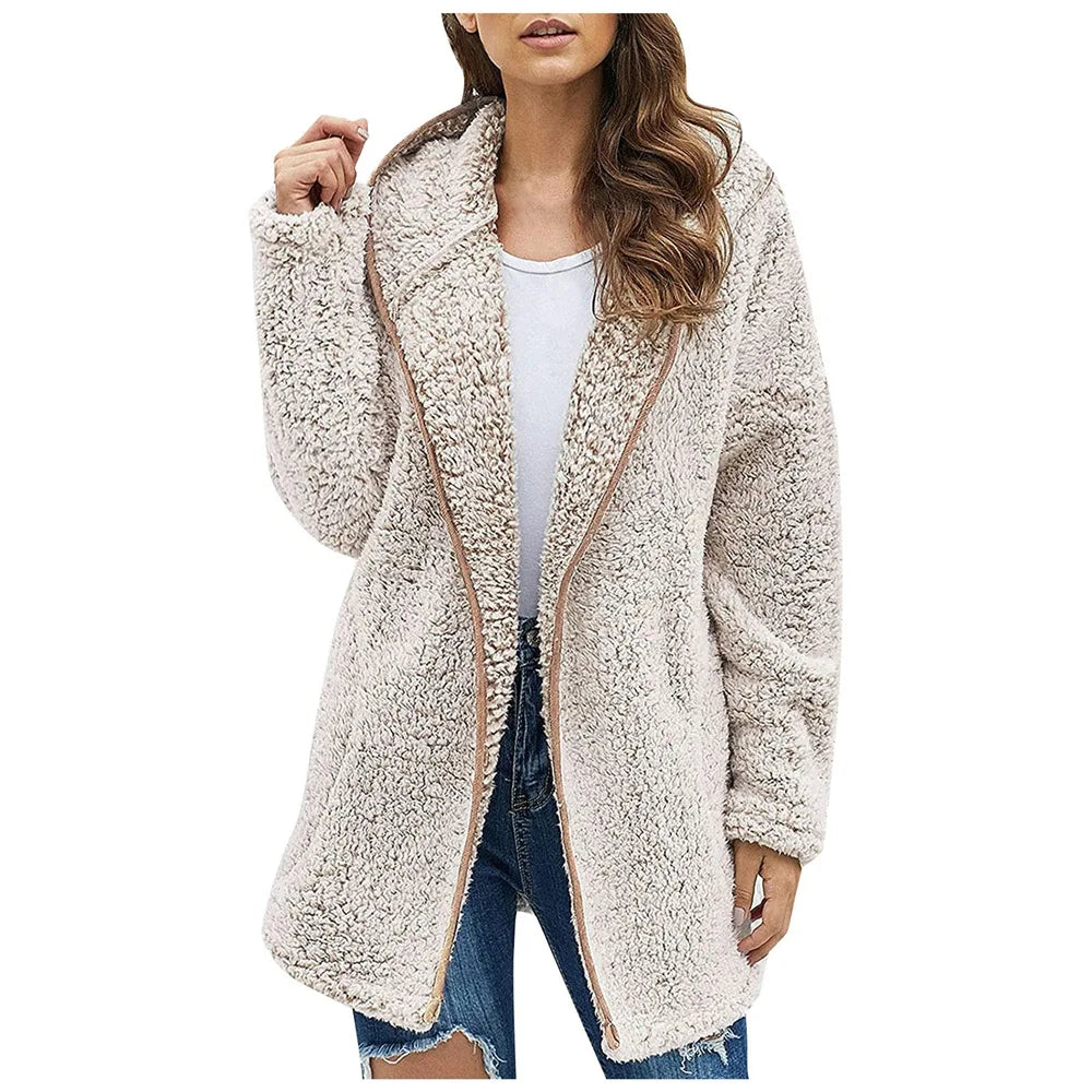 Woman wearing beige brushed sherpa hooded jacket with tan trim