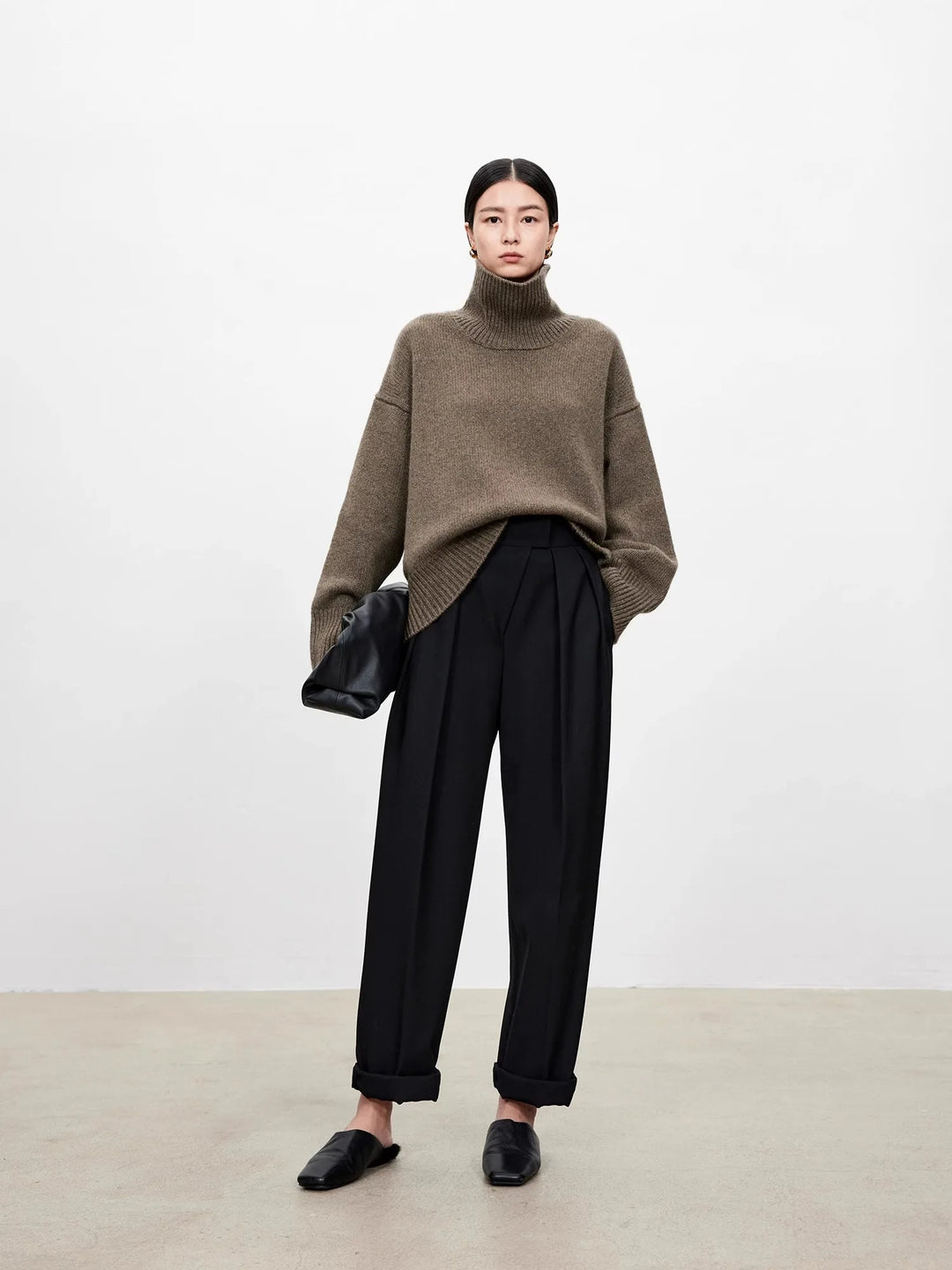 Brown turtleneck sweater with black tailored trousers and mules