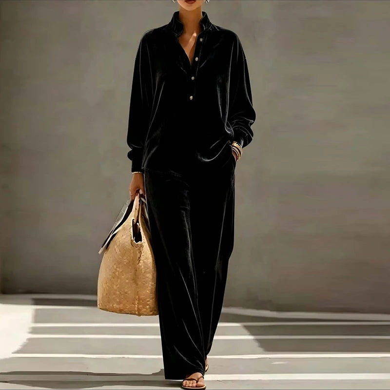 Woman wearing black velvet stand collar top and wide leg pants set