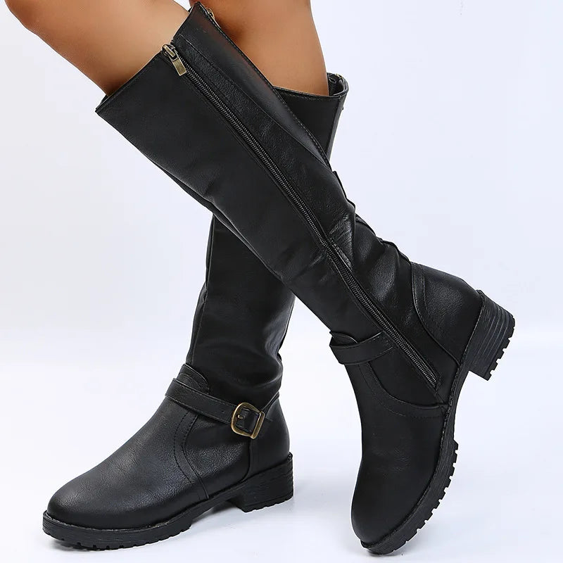 Black knee-high boots crossed pose showing zipper and buckle