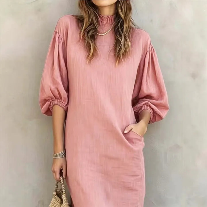 Woman wearing pink mock neck midi dress with balloon sleeves, front view