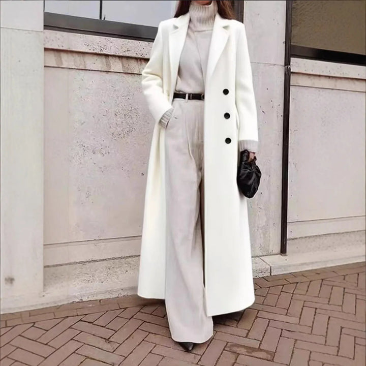 Woman wearing white long trench coat with button front detail