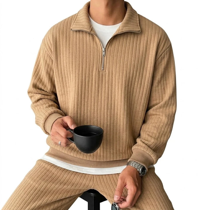 Man wearing khaki ribbed quarter-zip pullover, front view