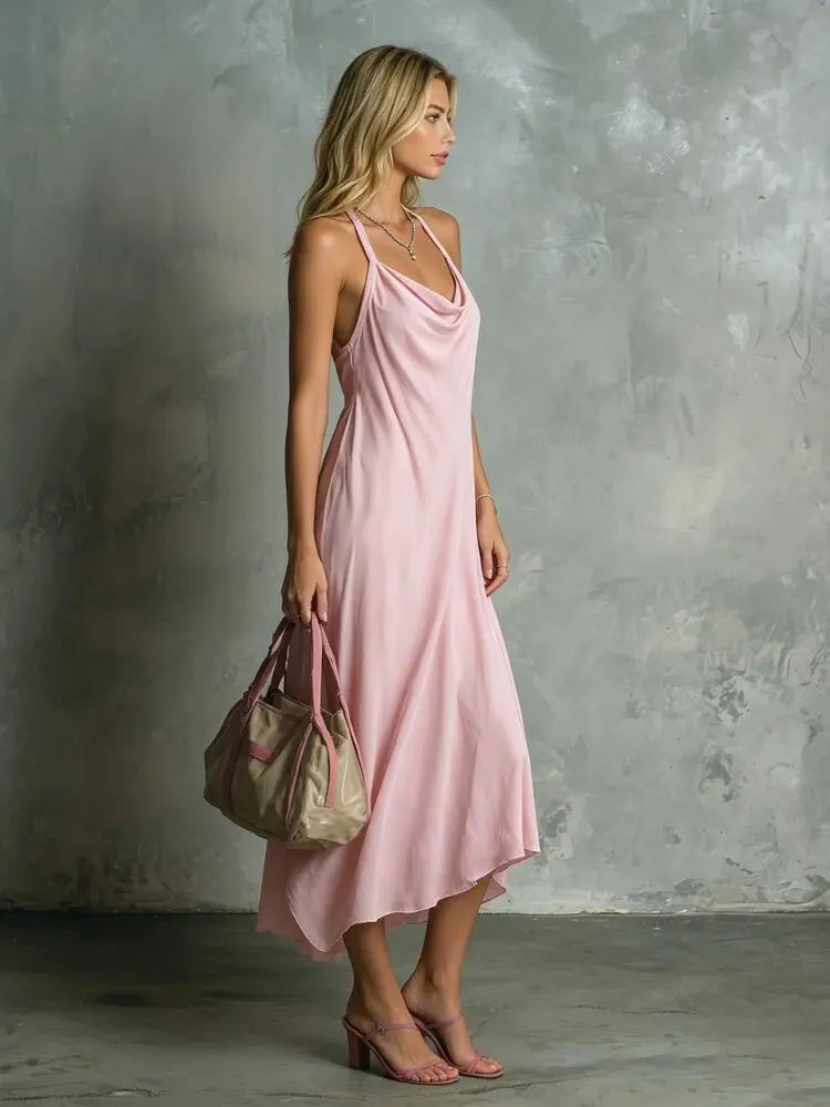 Side profile of woman in pink cowl neck halter midi dress