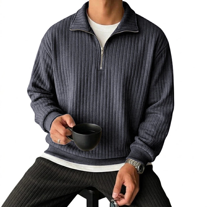 Man wearing dark gray ribbed quarter-zip pullover, front view