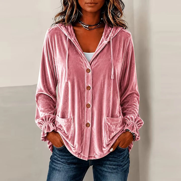 Woman wearing pink hooded velvet jacket with buttons