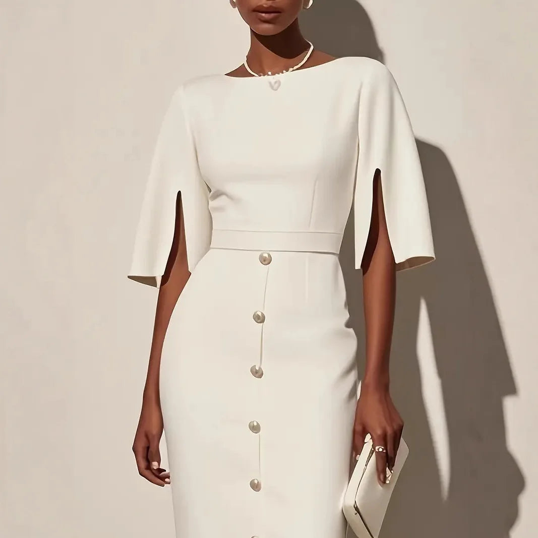Close up of white pencil dress bodice with split sleeves and pearl buttons