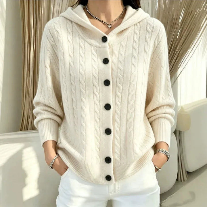 Woman wearing creamy white cable knit hooded cardigan buttoned up