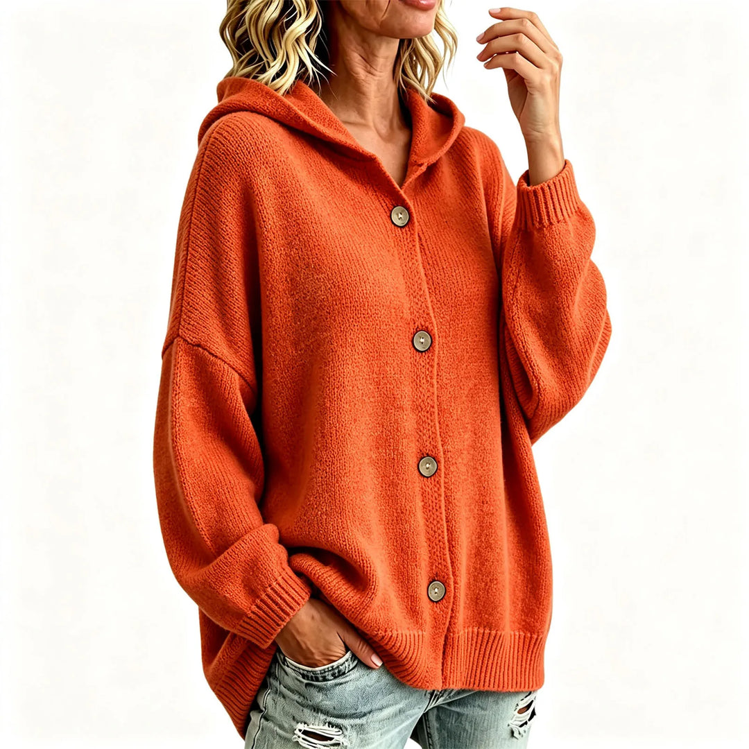 Orange hooded button front cardigan on model against plain background