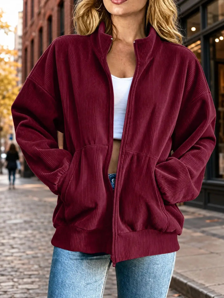 Woman wearing red corduroy zip-up jacket