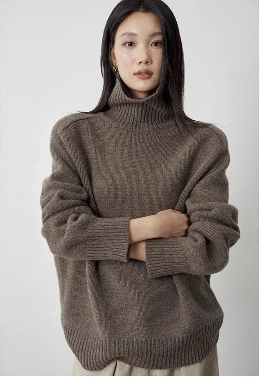 Woman wearing brown turtleneck sweater arms crossed
