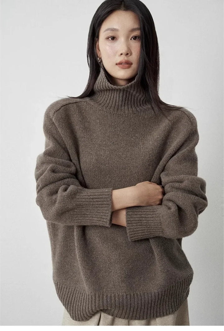 Woman wearing brown turtleneck sweater arms crossed
