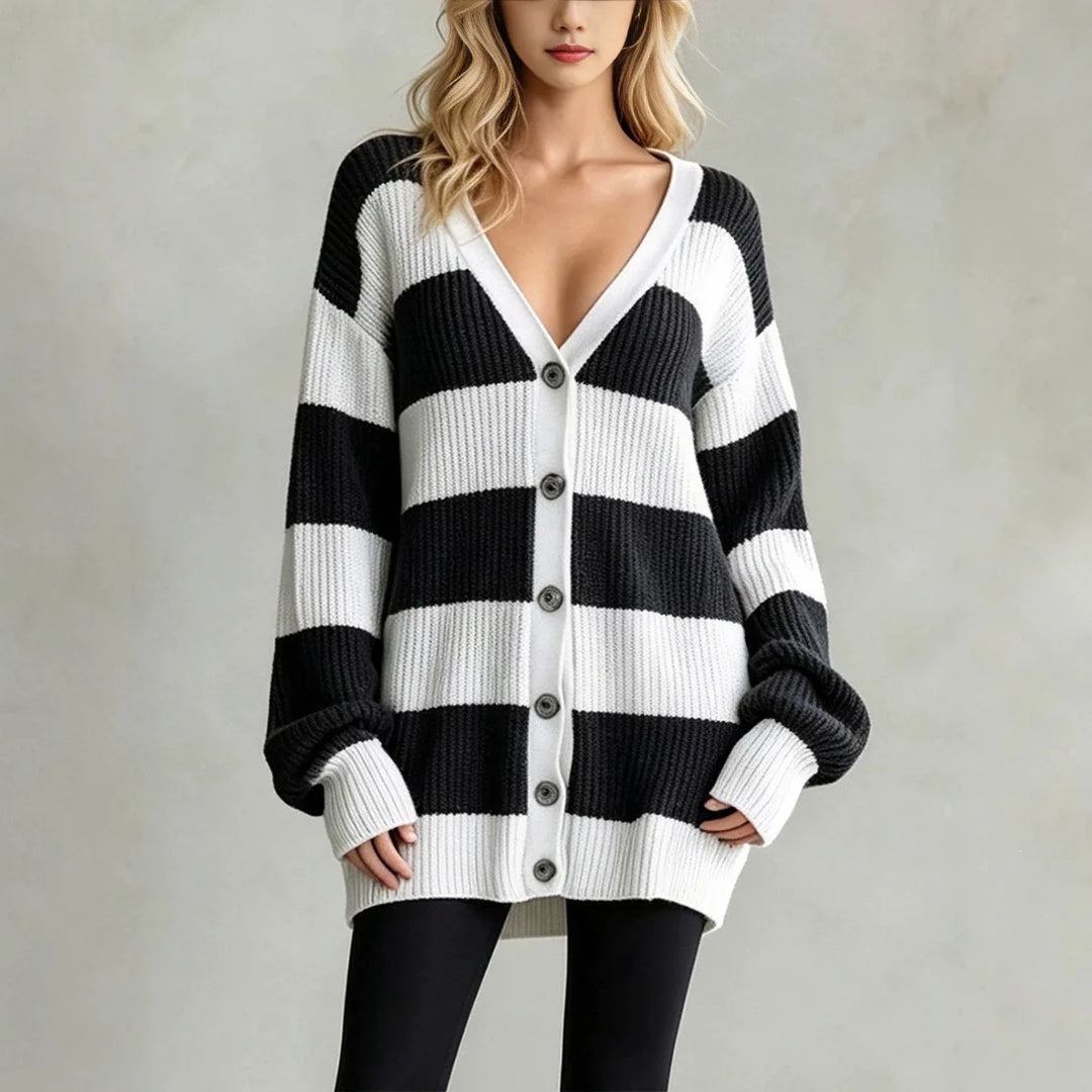 Woman wearing black and white striped oversized cardigan sweater