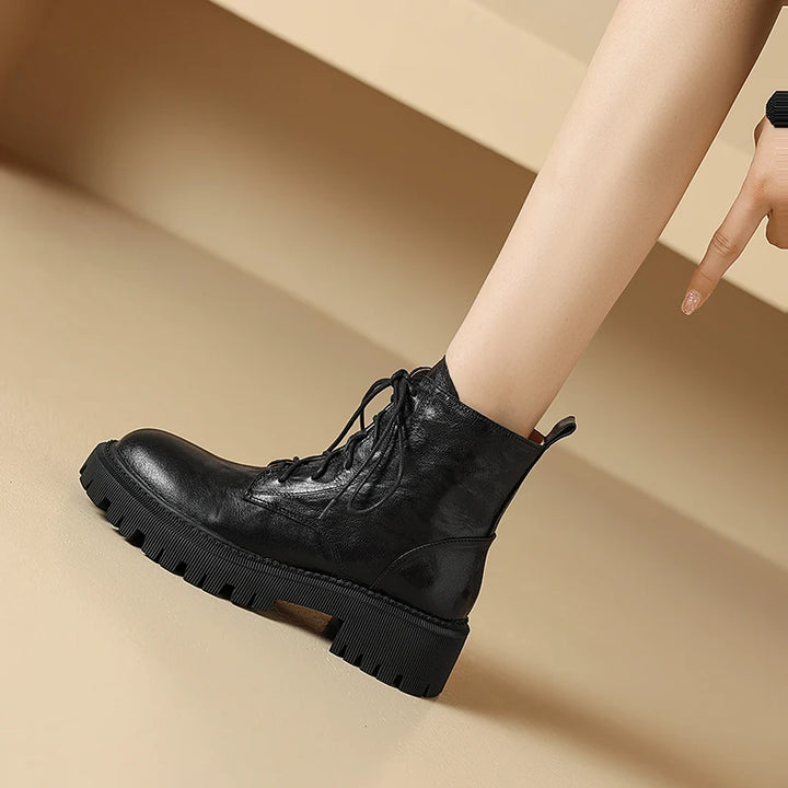 Close side view of black leather lace-up ankle boot