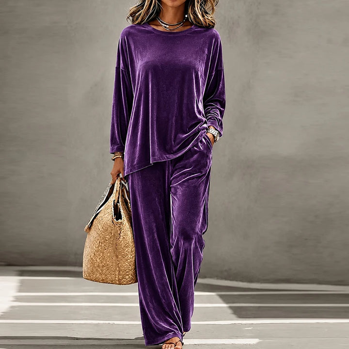Woman wearing purple velvet two piece pants set
