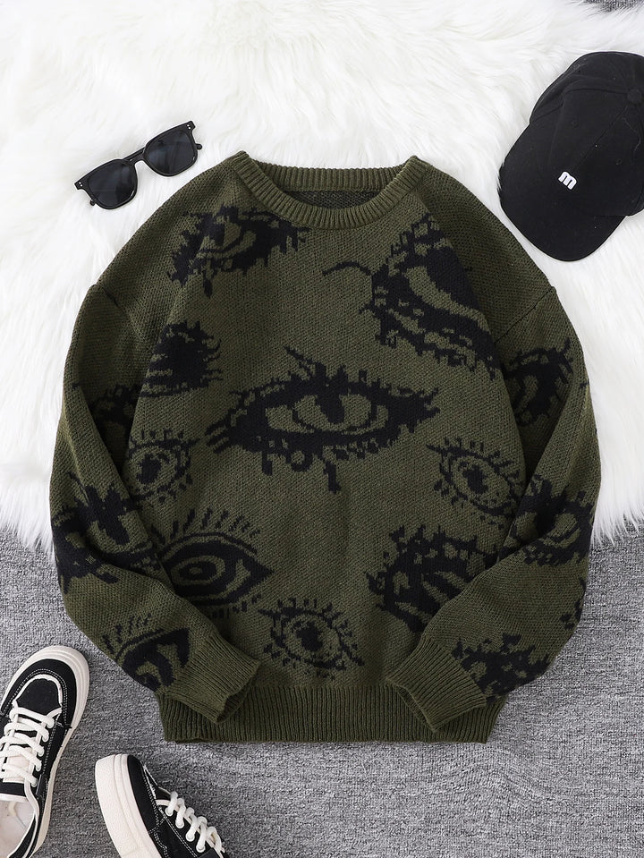 Olive green eye print sweater flat lay with accessories