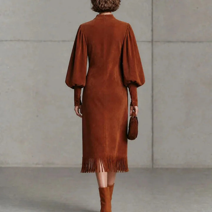 Back view of brown velvet lantern sleeve dress showing zip closure and fringe hem