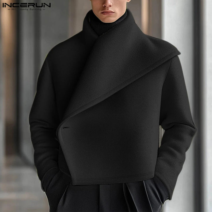 Man wearing black asymmetric shawl collar cropped jacket, front view