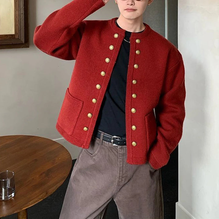 Man in red knit cardigan with gold buttons, front view