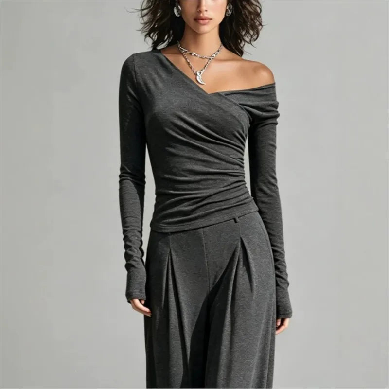 Close up of gray asymmetric off shoulder top with draped neckline