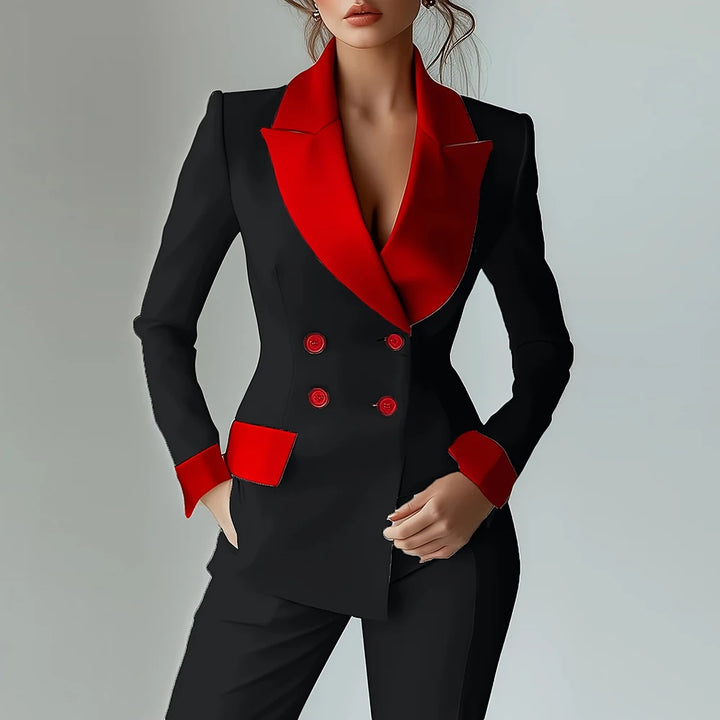 Woman wearing black blazer with red contrast lapel and cuffs